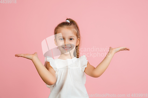 Image of Pretty caucasian girl portrait isolated on pink studio background with copyspace