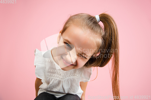 Image of Pretty caucasian girl portrait isolated on pink studio background with copyspace