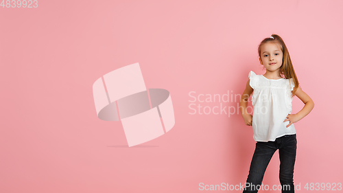 Image of Pretty caucasian girl portrait isolated on pink studio background with copyspace