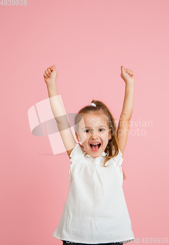 Image of Pretty caucasian girl portrait isolated on pink studio background with copyspace