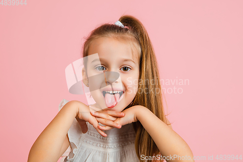 Image of Pretty caucasian girl portrait isolated on pink studio background with copyspace