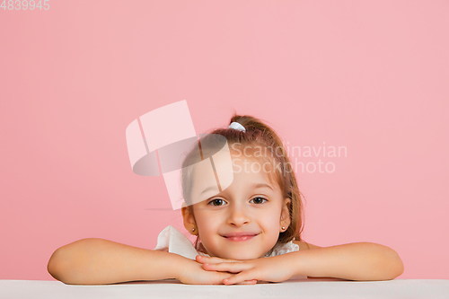 Image of Pretty caucasian girl portrait isolated on pink studio background with copyspace