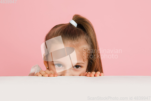 Image of Pretty caucasian girl portrait isolated on pink studio background with copyspace