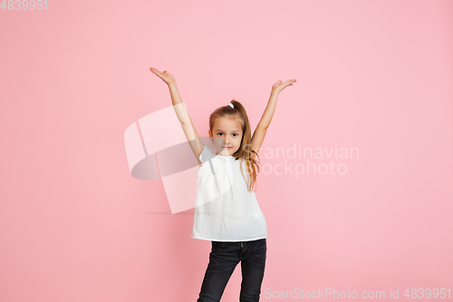 Image of Pretty caucasian girl portrait isolated on pink studio background with copyspace