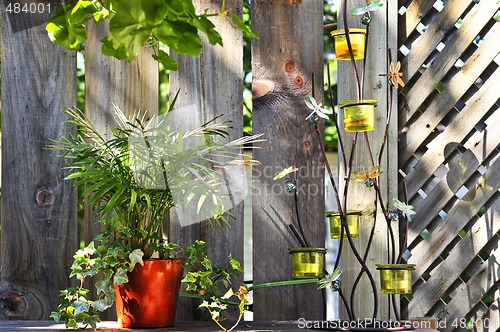 Image of Flower pots and decorations on house deck