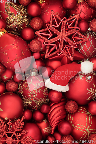 Image of Christmas Santa Hat and Red and Gold Bauble Background