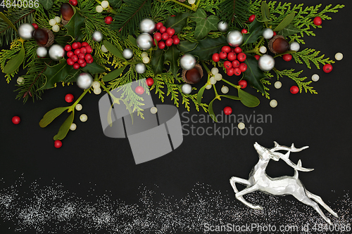 Image of Christmas Abstract Composition with Reindeer and Winter Greenery