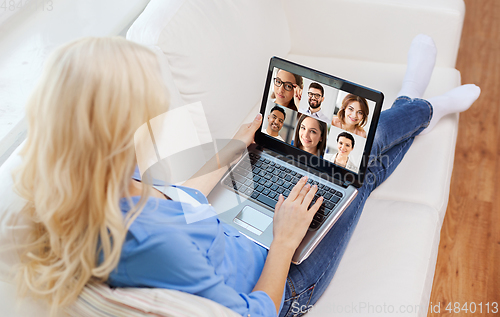 Image of woman with laptop has video call with colleagues