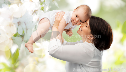 Image of happy mother with baby over cherry blossoms