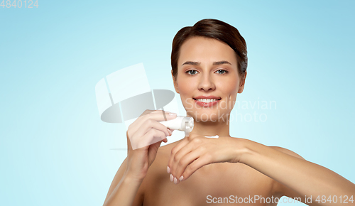 Image of woman applying moisturizing cream to her hand