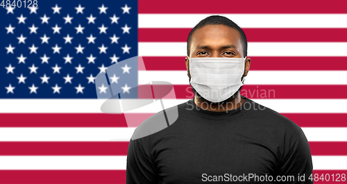 Image of african american man in protective medical mask