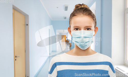 Image of teenage girl in medical mask over school corridor