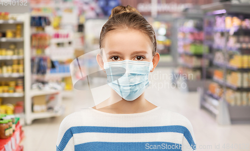 Image of teenage girl in mask over supermarket