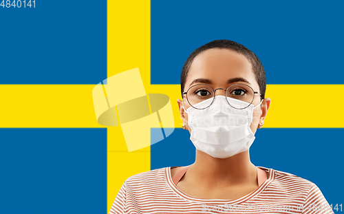 Image of woman in protective mask over flag of sweden