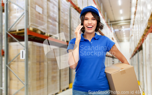 Image of delivery girl with parcel box calls on smartphone