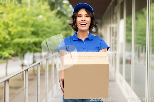 Image of happy delivery girl with parcel box in blue