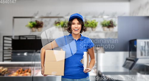 Image of happy delivery girl with box and clipboard