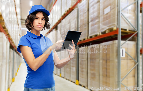 Image of delivery girl with tablet pc at warehouse