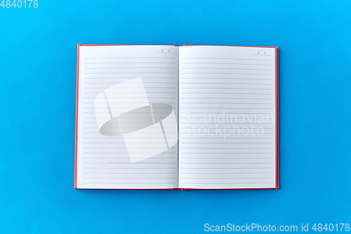 Image of open notebook or diary on blue background