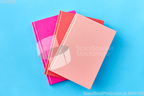 Image of notebooks or books on blue background