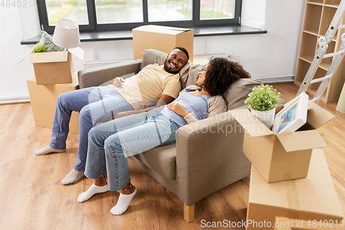 Image of happy couple with boxes moving to new home