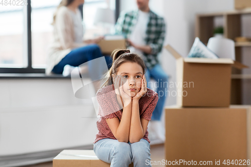 Image of sad girl moving to new home with her family