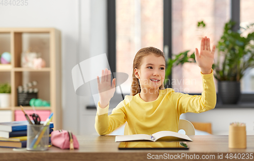 Image of student girl touching something imaginary at home