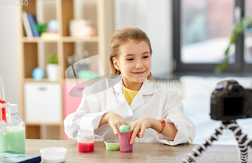 Image of girl with slime and camera video blogging at home