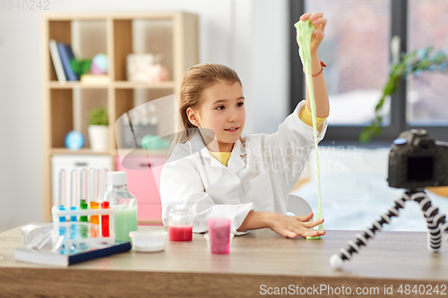 Image of girl with slime and camera video blogging at home