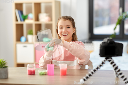 Image of girl with slime and camera video blogging at home