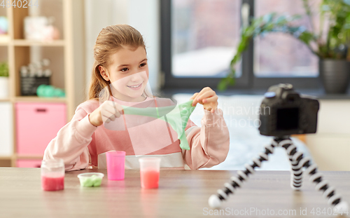 Image of girl with slime and camera video blogging at home
