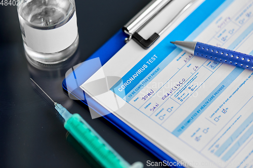 Image of medical report, pen, syringe and medicine