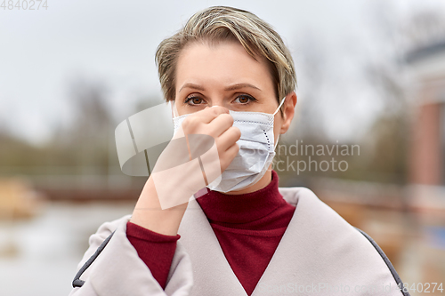 Image of young woman wearing protective medical mask