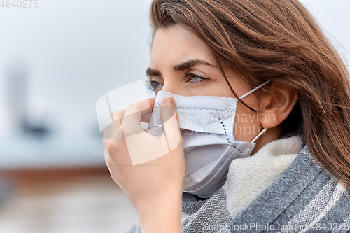 Image of young woman wearing protective medical mask