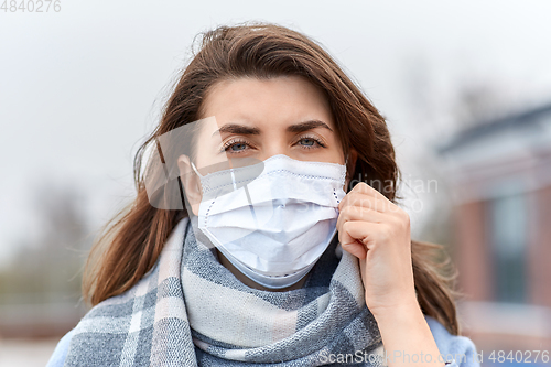 Image of young woman wearing protective medical mask