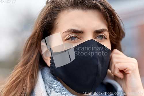 Image of woman wearing protective reusable barrier mask