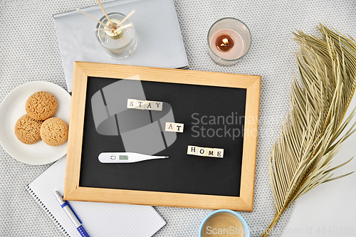 Image of chalkboard with stay at home words on toy blocks