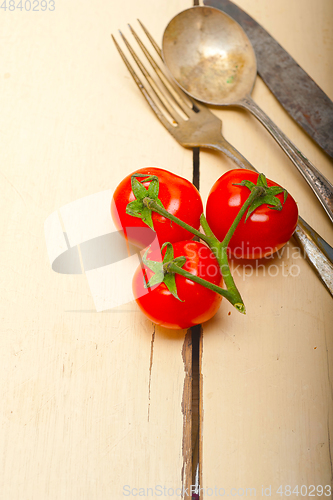 Image of ripe cherry tomatoes over white wood
