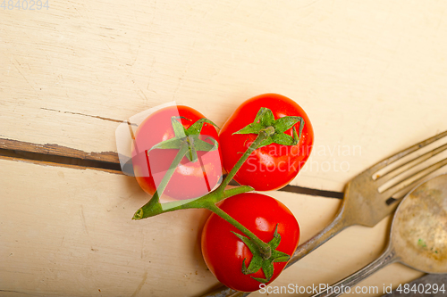 Image of ripe cherry tomatoes over white wood