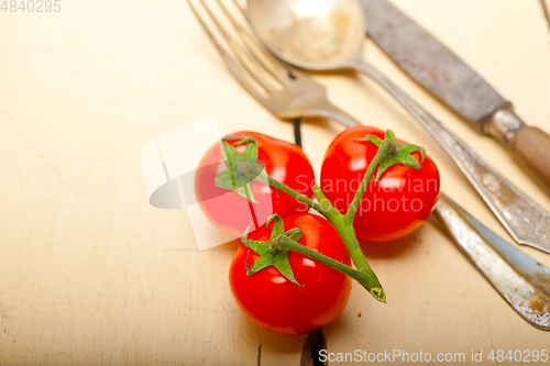 Image of ripe cherry tomatoes over white wood