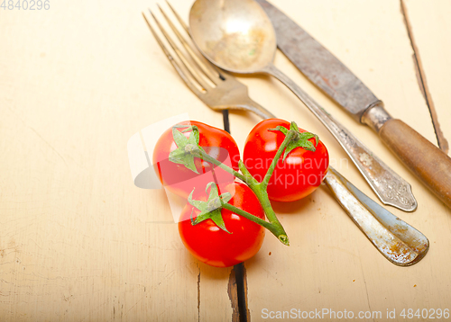 Image of ripe cherry tomatoes over white wood
