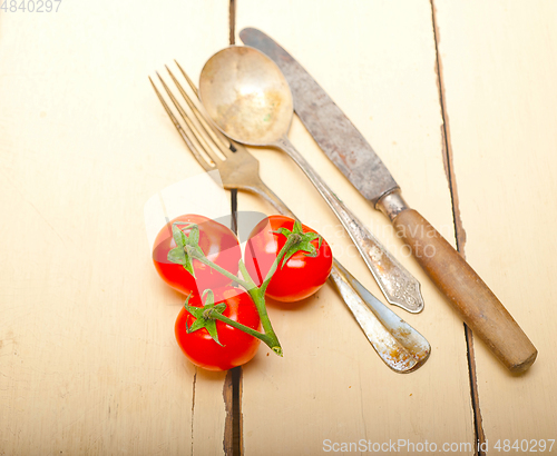 Image of ripe cherry tomatoes over white wood