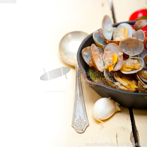 Image of fresh clams on an iron skillet