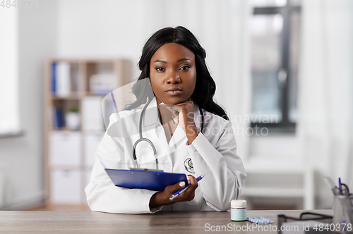 Image of african american doctor with clipboard at hospital