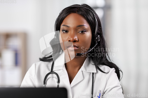 Image of african doctor with headset and laptop at hospital