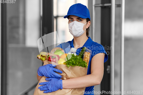 Image of delivery woman in face mask with food in paper bag