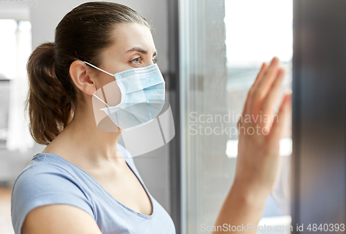 Image of sick young woman wearing protective medical mask