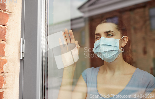 Image of sick young woman wearing protective medical mask