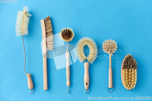 Image of different cleaning brushes on blue background