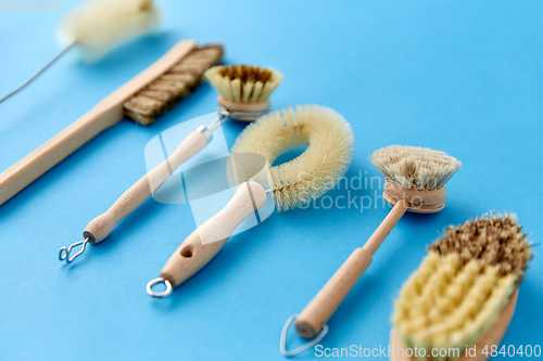Image of different cleaning brushes on blue background